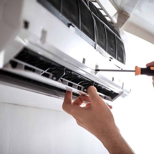 HVAC technician servicing an air conditioning system
